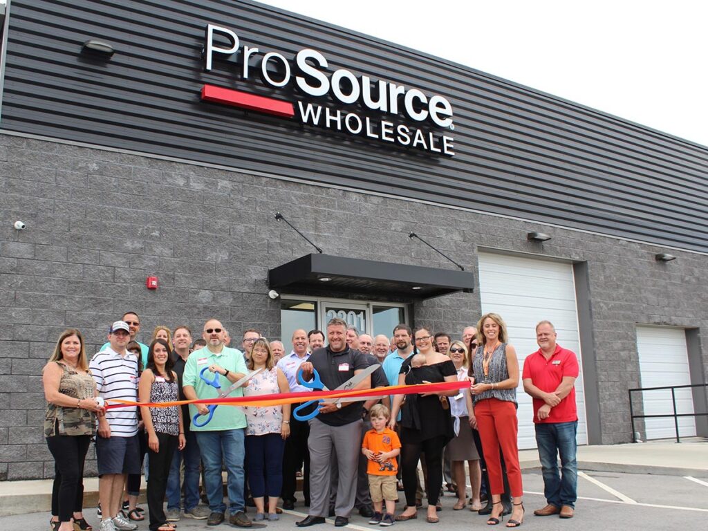 ProSource franchisees cutting a ribbon with large scissors
